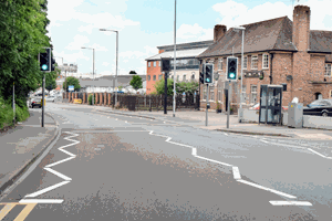 White zig-zag lines on the road approaching a pedestrian crossing